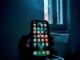 “Anonymous person holding a smartphone, symbolizing loss of privacy after nonconsensual intimate images are shared online”